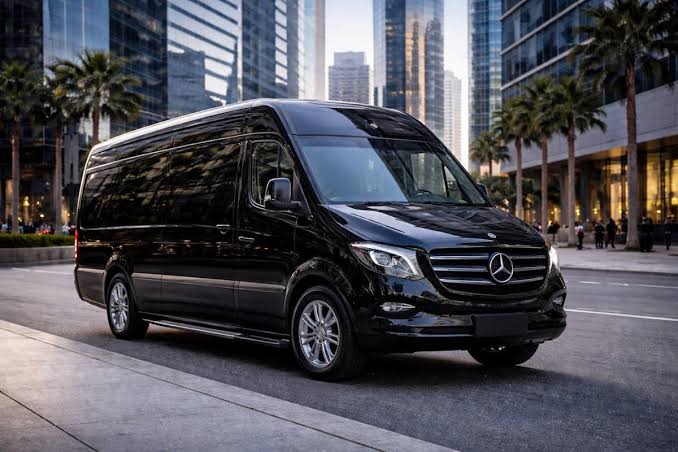 Excalibur-branded matte black Mercedes-Benz Sprinter in daylight, Oklahoma City