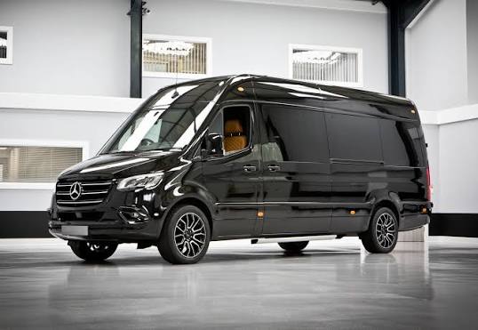 The Avalon Mercedes-Benz Sprinter limousine at dusk — Excalibur wedding transportation, Oklahoma